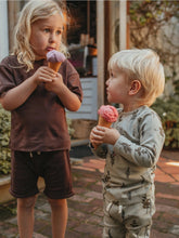 Load image into Gallery viewer, two children standing outside eating ice cream wearing Ziwi Baby sets
