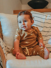 Load image into Gallery viewer, baby sitting on a couch wearing a sun short sleeve onesie and drawstring pants set by Ziwi Baby
